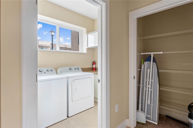 washroom featuring independent washer and dryer and light tile floors