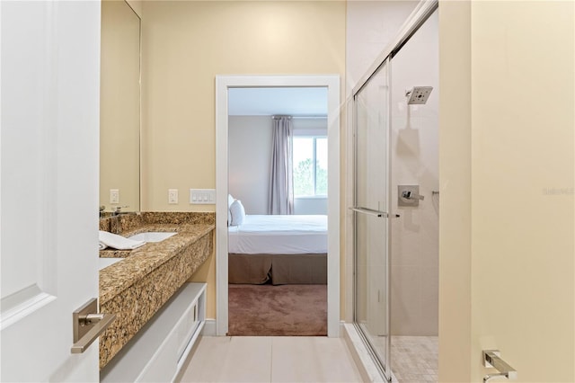 bathroom with an enclosed shower, tile flooring, and sink