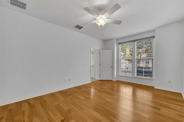 spare room with light wood-type flooring and ceiling fan