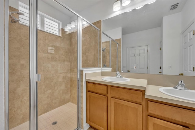 bathroom featuring vanity and a shower with shower door