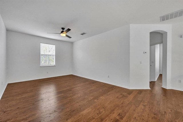 empty room featuring dark hardwood / wood-style flooring and ceiling fan