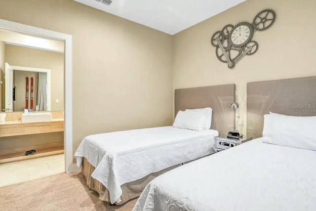 bedroom with tile floors and ensuite bathroom