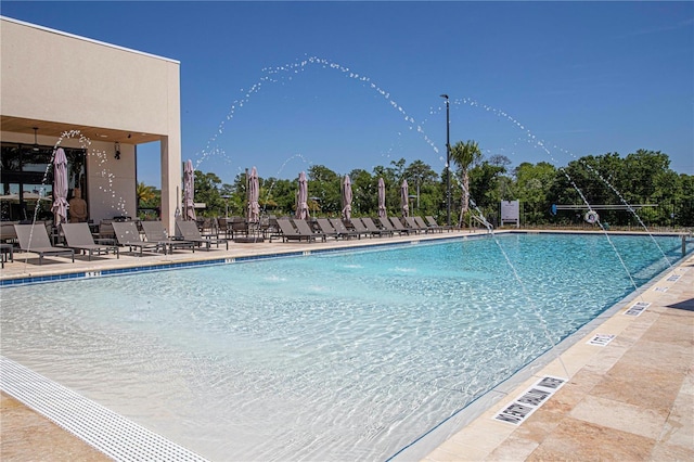 view of pool with a patio and pool water feature