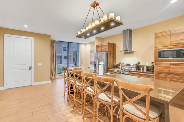 dining room with sink and light hardwood / wood-style flooring