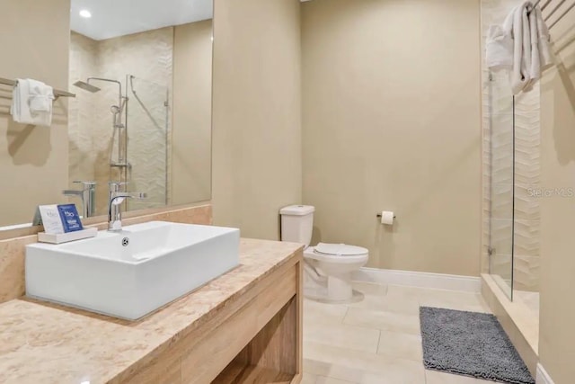 bathroom with tile floors, a shower with door, toilet, and vanity