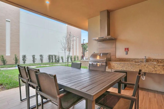 view of patio with grilling area and sink