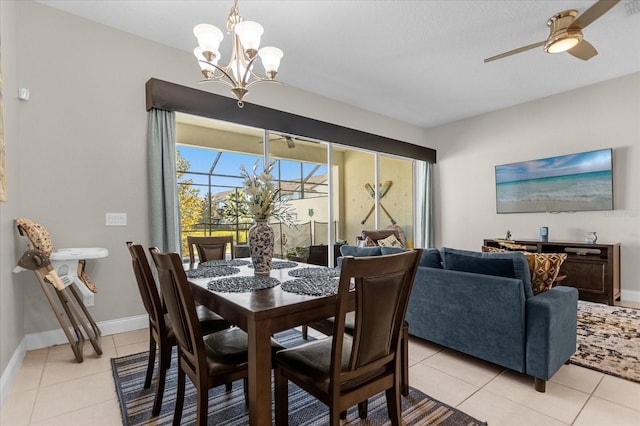 tiled dining room with ceiling fan with notable chandelier