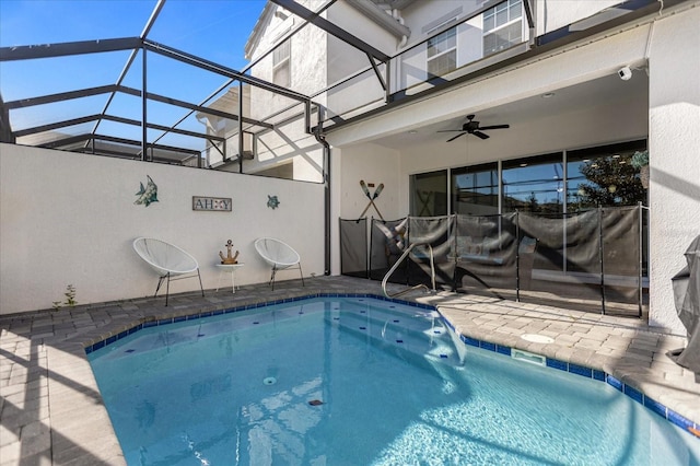 view of pool featuring a lanai, ceiling fan, and a patio