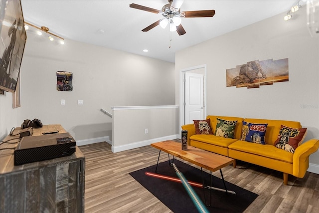 living room with rail lighting, light hardwood / wood-style floors, and ceiling fan