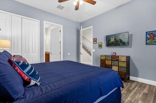 bedroom with a closet, ceiling fan, and dark hardwood / wood-style flooring