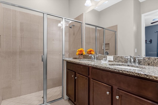 bathroom featuring oversized vanity, dual sinks, and walk in shower