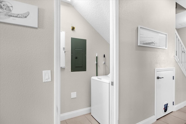 clothes washing area featuring light tile floors and washer / clothes dryer