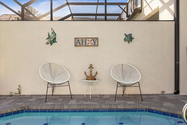 view of swimming pool with glass enclosure