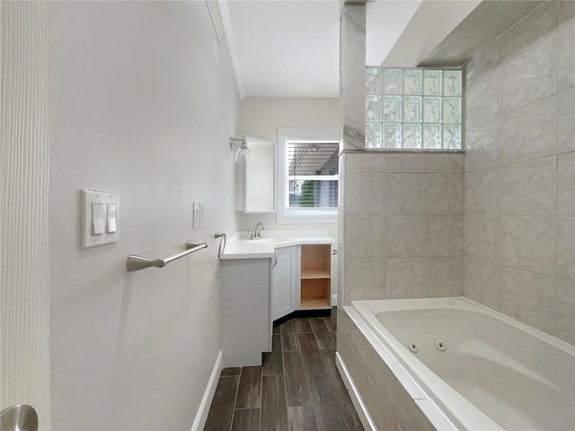 bathroom featuring crown molding, hardwood / wood-style floors, vanity, and tiled shower / bath combo