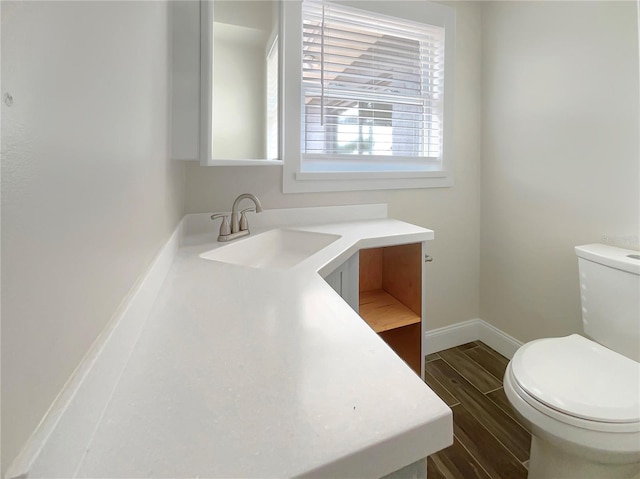 bathroom featuring hardwood / wood-style floors, vanity, and toilet