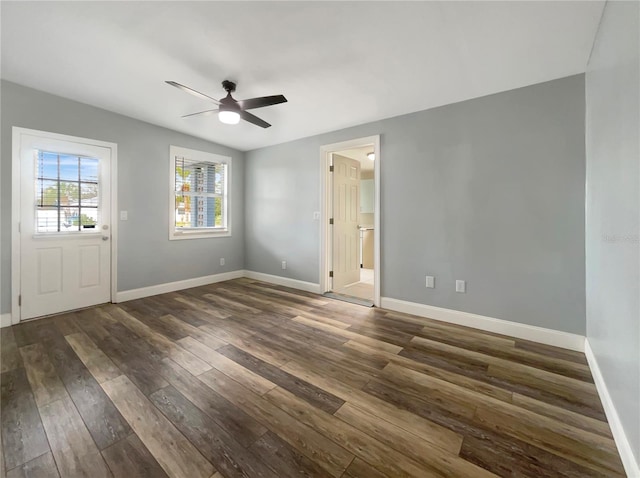 unfurnished room featuring ceiling fan and dark wood-type flooring