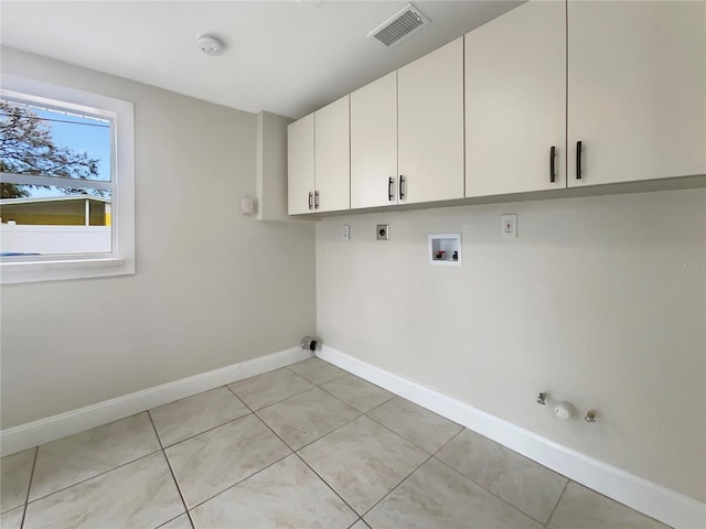 laundry area with hookup for an electric dryer, hookup for a washing machine, cabinets, gas dryer hookup, and light tile patterned floors