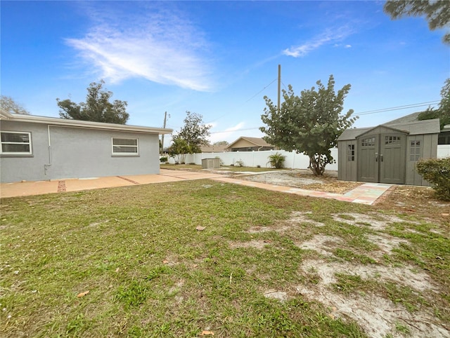 view of yard featuring a patio and a storage unit