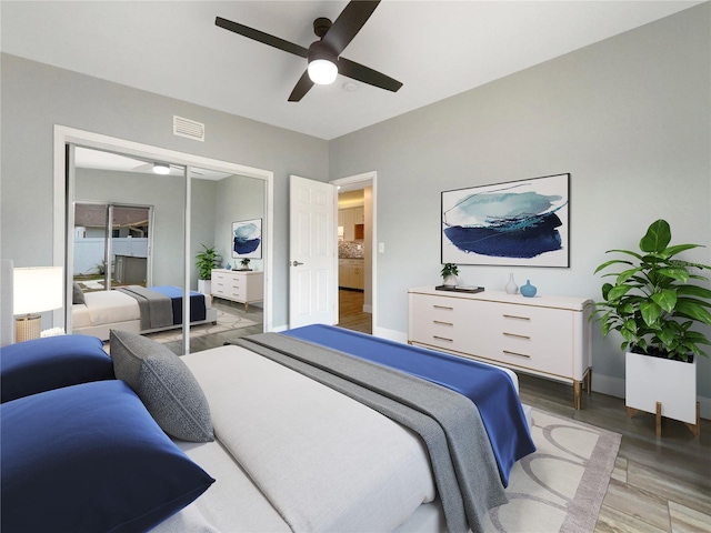 bedroom with hardwood / wood-style floors, ceiling fan, and a closet