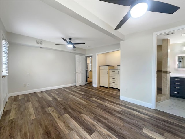 unfurnished living room with ceiling fan and dark wood-type flooring