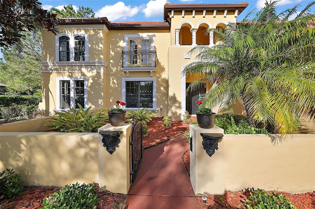 mediterranean / spanish-style home featuring a balcony