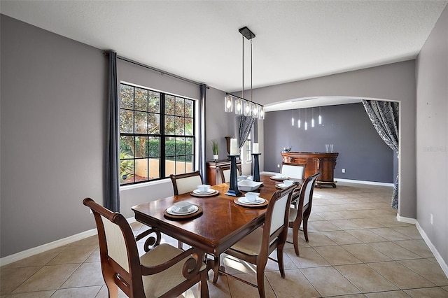 dining room featuring a chandelier and light tile patterned floors