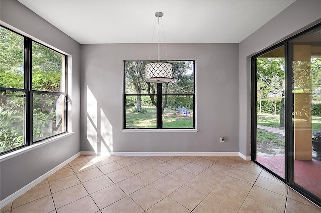 unfurnished dining area with light tile patterned floors and a healthy amount of sunlight