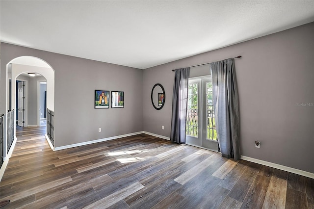 unfurnished room featuring dark wood-type flooring and french doors