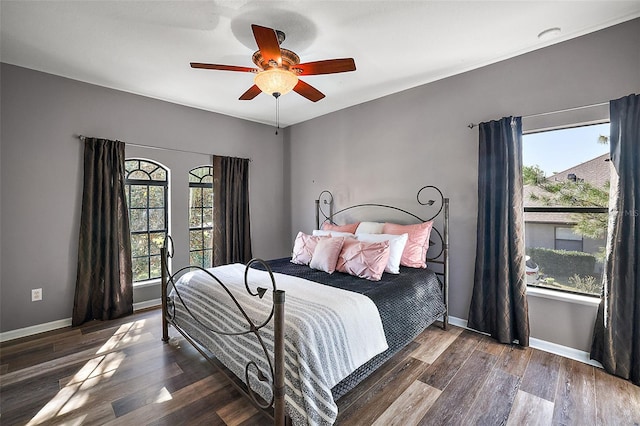 bedroom featuring ceiling fan and dark wood-type flooring