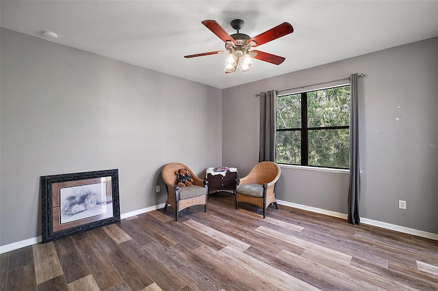 living area featuring ceiling fan and wood-type flooring