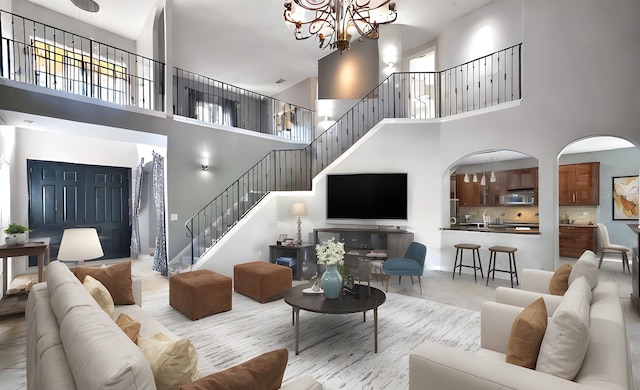 living room with a chandelier and a high ceiling