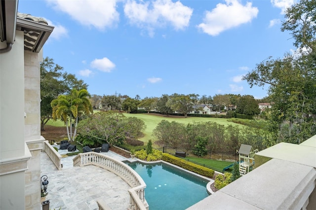 view of swimming pool with a yard and a patio area