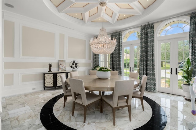 dining space featuring light tile flooring, french doors, a chandelier, and coffered ceiling