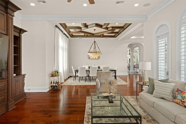 living room with ceiling fan, coffered ceiling, dark hardwood / wood-style flooring, beam ceiling, and crown molding