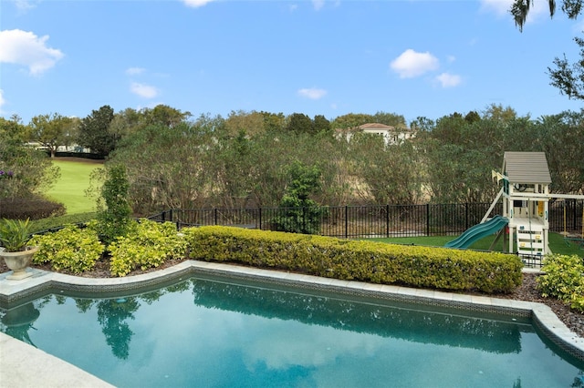 view of swimming pool featuring a playground