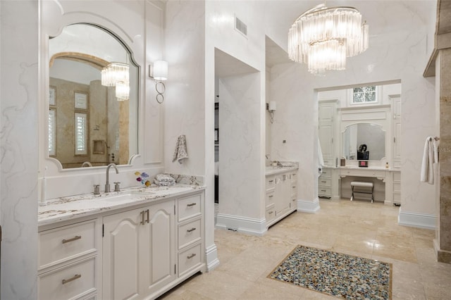 bathroom with a notable chandelier, dual vanity, and tile floors