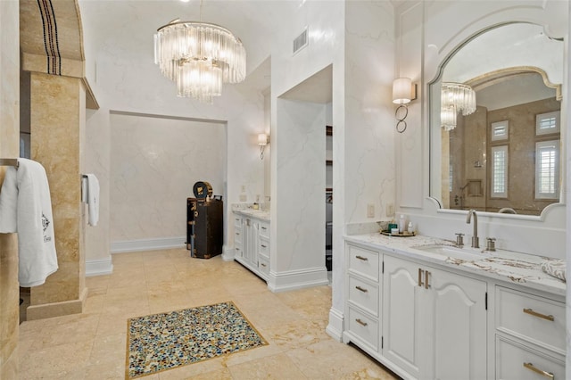 bathroom with a chandelier, tile flooring, and vanity