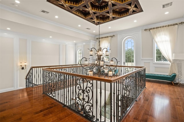 corridor featuring an inviting chandelier, dark wood-type flooring, crown molding, and coffered ceiling