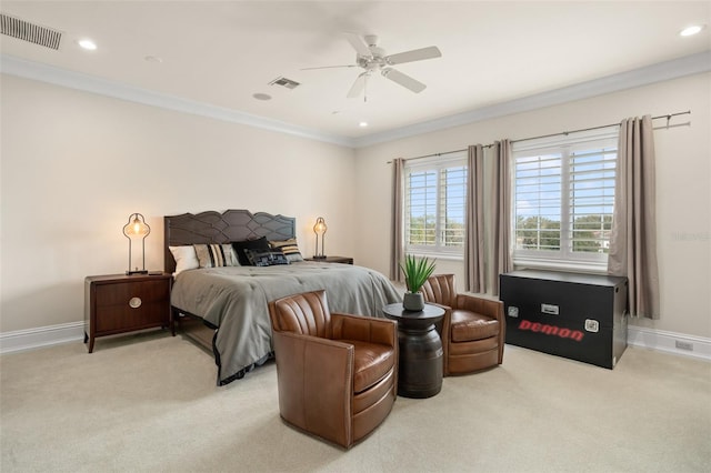 carpeted bedroom with ornamental molding and ceiling fan