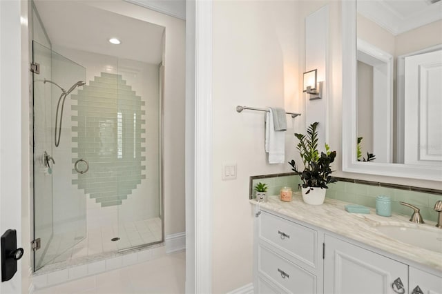 bathroom with crown molding, an enclosed shower, tile floors, and vanity