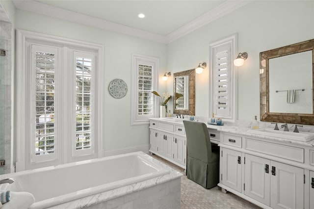 bathroom with vanity, crown molding, and tiled bath