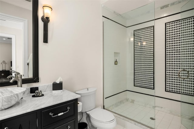 bathroom featuring a shower with door, toilet, and large vanity