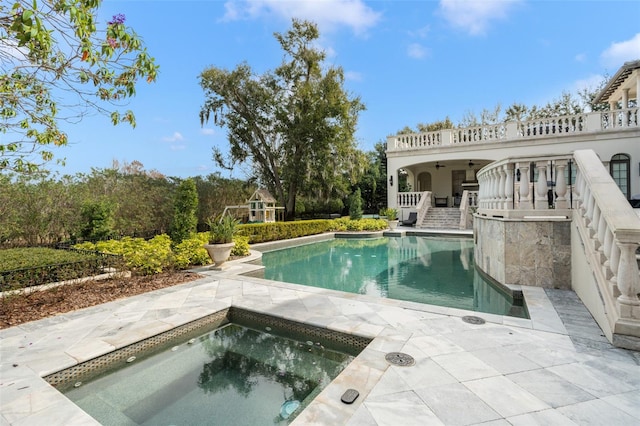 view of swimming pool with a patio and an in ground hot tub