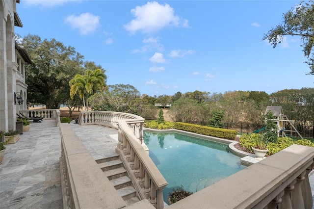 view of swimming pool with a patio area