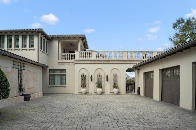 exterior space with a garage and a balcony