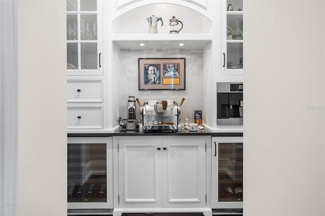 bar with backsplash, wine cooler, and white cabinets