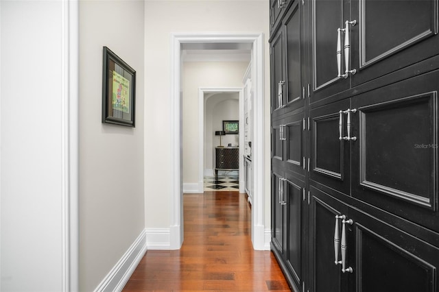 corridor with dark hardwood / wood-style flooring