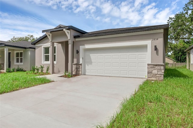 view of front of property with a garage and a front lawn