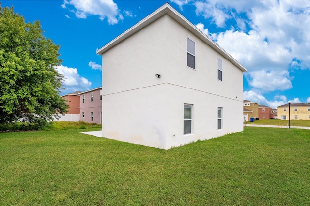 rear view of property featuring a yard