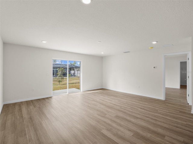 empty room with light hardwood / wood-style flooring